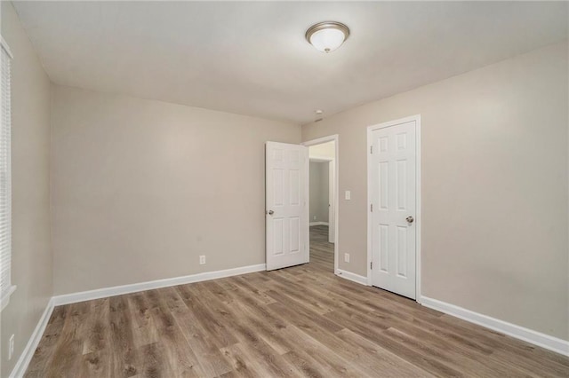 unfurnished room with hardwood / wood-style flooring