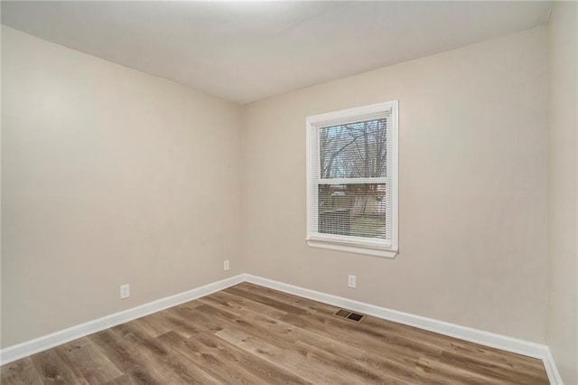 empty room with hardwood / wood-style flooring