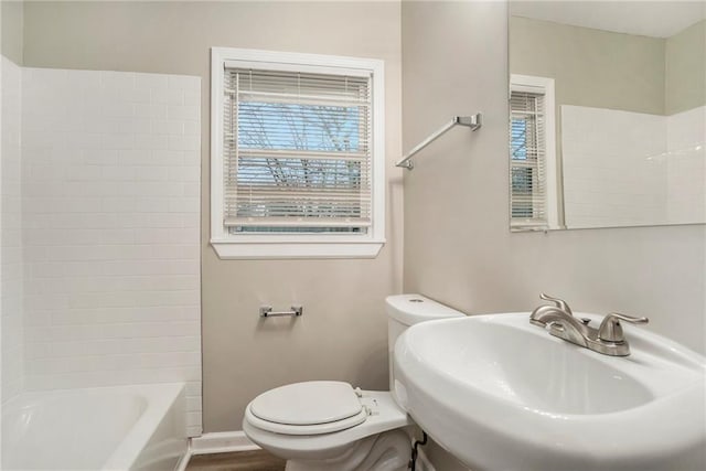 full bathroom featuring shower / tub combination, sink, hardwood / wood-style floors, and toilet