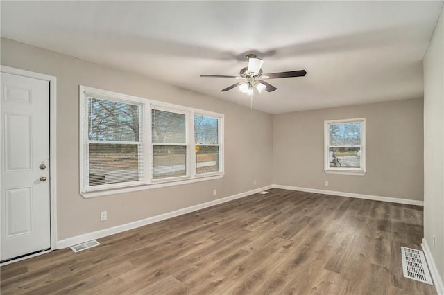 spare room featuring hardwood / wood-style flooring and ceiling fan