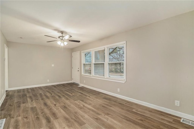 unfurnished room with hardwood / wood-style flooring and ceiling fan