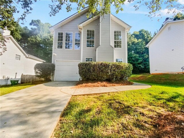 view of front property featuring a front lawn and a garage