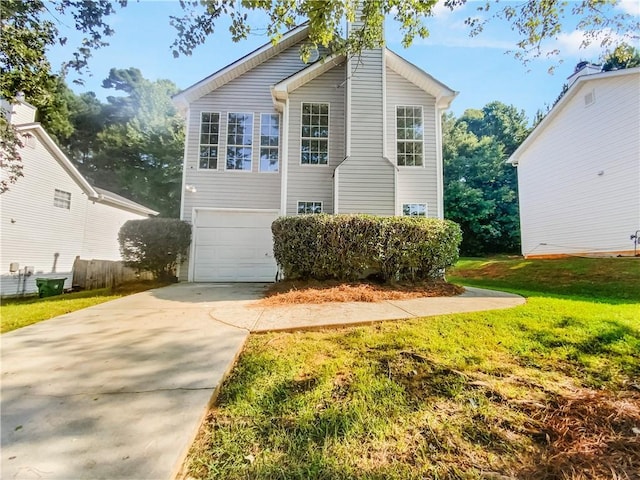 view of front of house with a garage and a front lawn