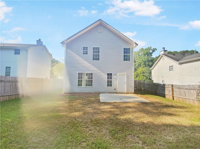 back of house featuring a patio and a yard