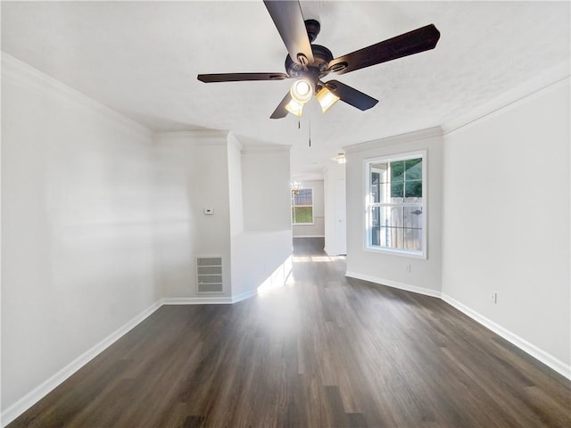 spare room with dark wood-type flooring, crown molding, and ceiling fan