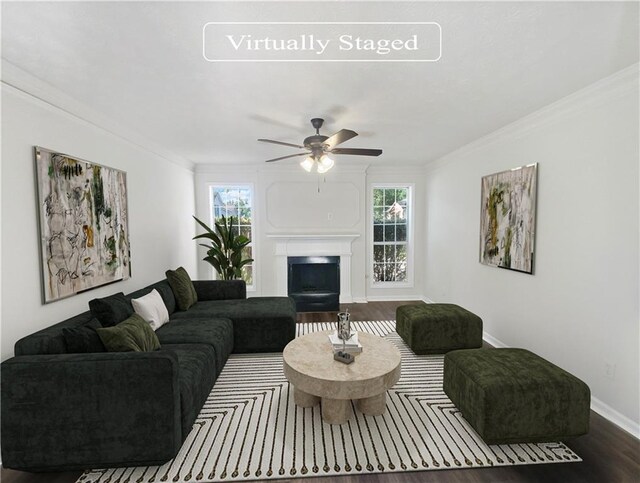 living room with ceiling fan, hardwood / wood-style flooring, plenty of natural light, and ornamental molding