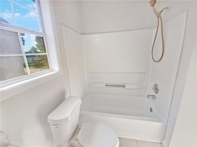 bathroom with toilet and bathing tub / shower combination