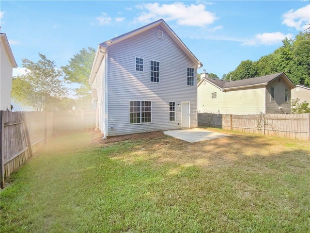 back of property with a patio and a lawn