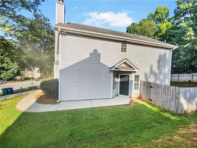 rear view of house with a yard