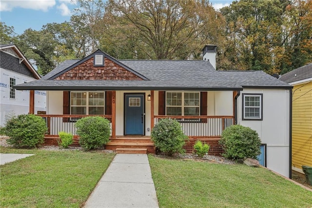 view of front of home featuring covered porch and a front lawn