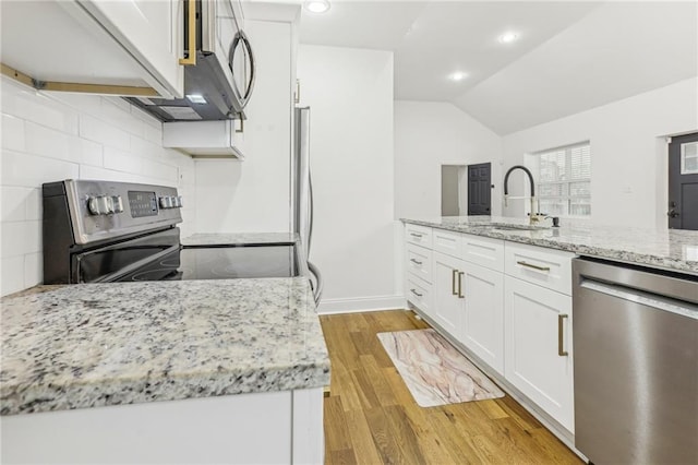 kitchen featuring light stone countertops, appliances with stainless steel finishes, sink, and white cabinets