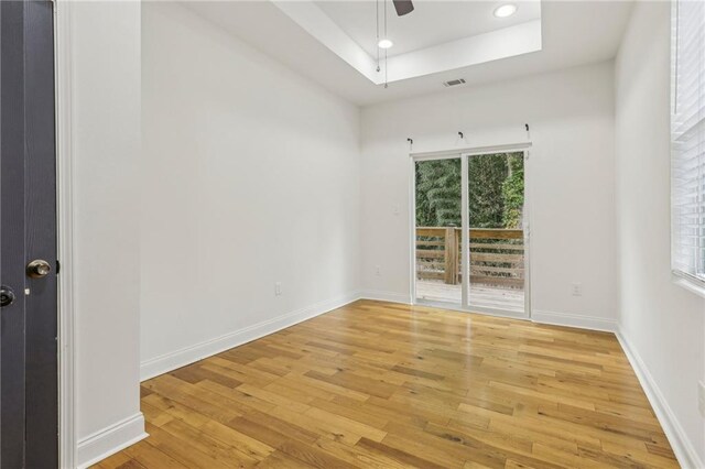 spare room featuring hardwood / wood-style flooring and vaulted ceiling