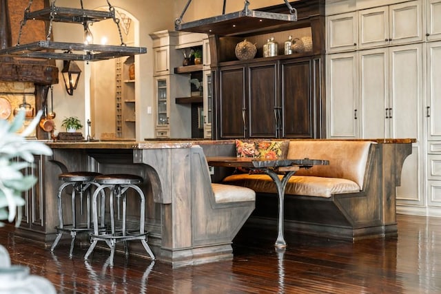 bar with built in shelves and hardwood / wood-style flooring