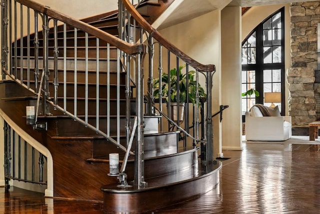 staircase with baseboards and hardwood / wood-style flooring