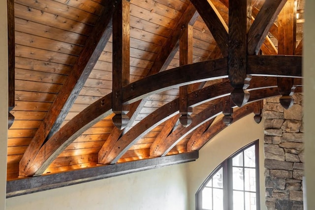 details with arched walkways, beam ceiling, and wooden ceiling