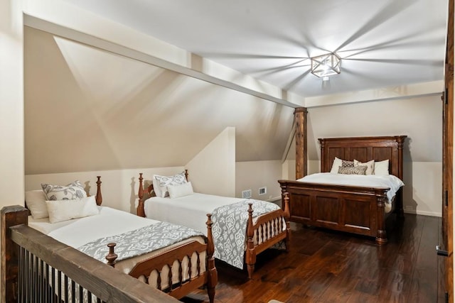 bedroom with lofted ceiling and dark wood-type flooring