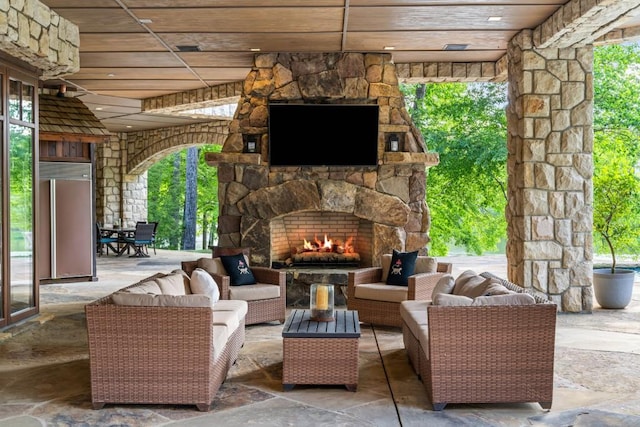 view of patio featuring an outdoor living space with a fireplace