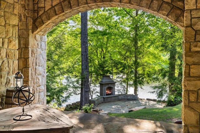 view of patio with an outdoor stone fireplace