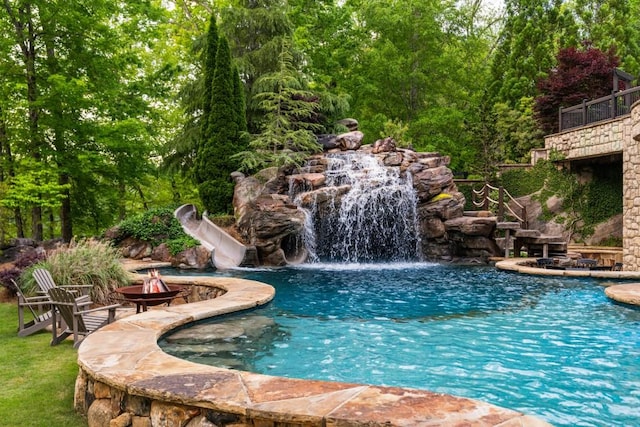 view of pool with an outdoor fire pit