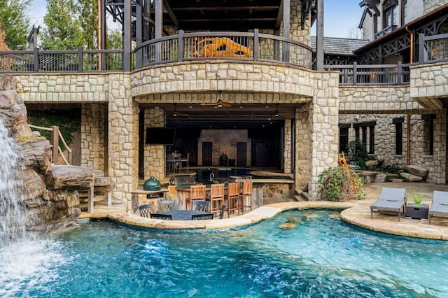 outdoor pool featuring a patio and outdoor dry bar