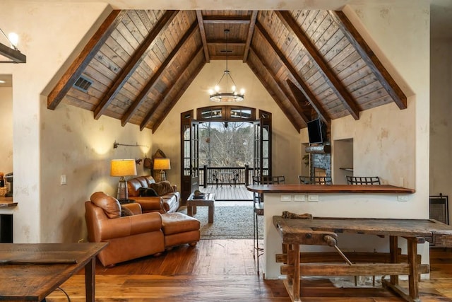 living room with wood-type flooring, wood ceiling, a notable chandelier, and beamed ceiling