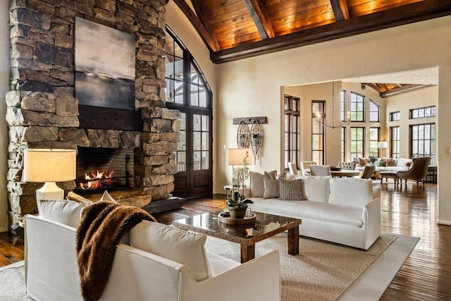 living room with high vaulted ceiling, beam ceiling, hardwood / wood-style floors, and wooden ceiling