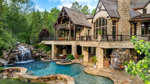 pool with a water slide and a patio area