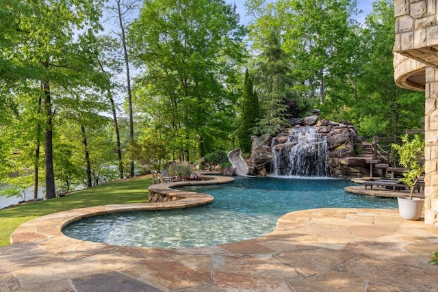 pool with a lawn and a patio