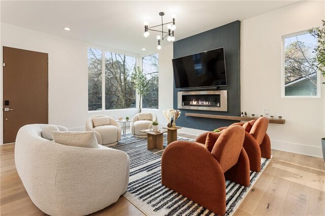 1045 Shepherds Ln NE, Atlanta, GA 30324 - living room with wood finished floors, a notable chandelier, and a healthy amount of sunlight