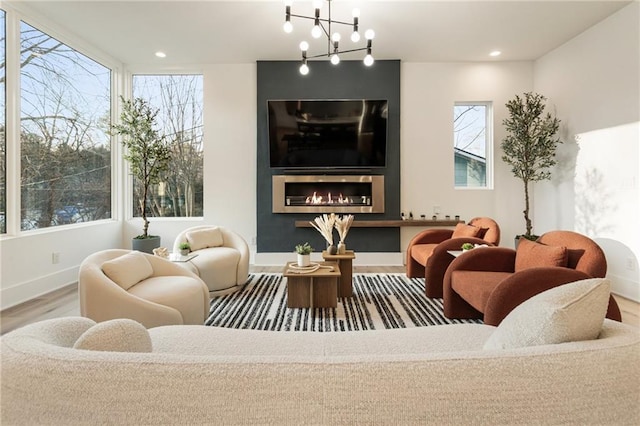 1045 Shepherds Ln NE, Atlanta, GA 30324 - living room with wood finished floors, a healthy amount of sunlight, baseboards, and a chandelier