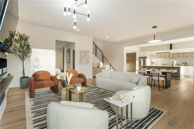 1045 Shepherds Ln NE, Atlanta, GA 30324 - living area with recessed lighting, a chandelier, stairs, and light wood finished floors