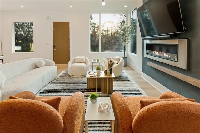 1045 Shepherds Ln NE, Atlanta, GA 30324 - living room featuring recessed lighting, baseboards, a glass covered fireplace, and wood finished floors