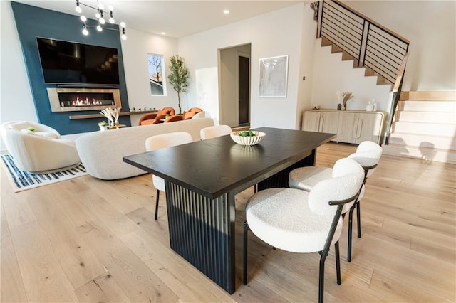 1045 Shepherds Ln NE, Atlanta, GA 30324 - dining space featuring light wood finished floors, stairway, recessed lighting, and a fireplace