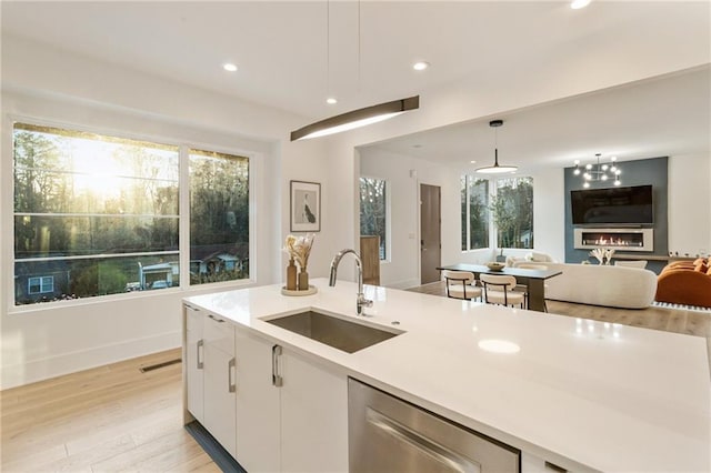 1045 Shepherds Ln NE, Atlanta, GA 30324 - kitchen with a sink, stainless steel dishwasher, open floor plan, white cabinetry, and light countertops