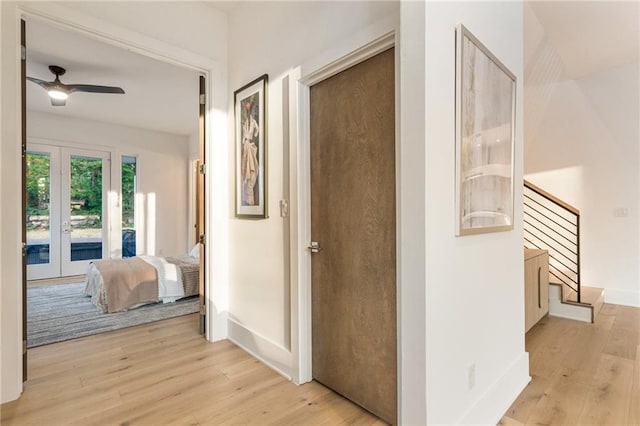 1045 Shepherds Ln NE, Atlanta, GA 30324 - hall featuring light wood finished floors, french doors, stairs, and baseboards