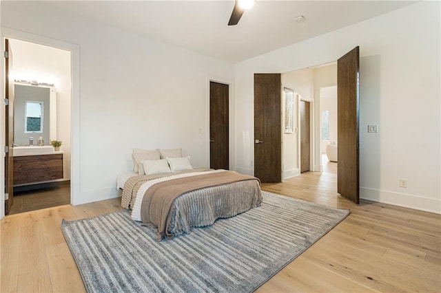 1045 Shepherds Ln NE, Atlanta, GA 30324 - bedroom featuring ceiling fan, baseboards, light wood-type flooring, and connected bathroom