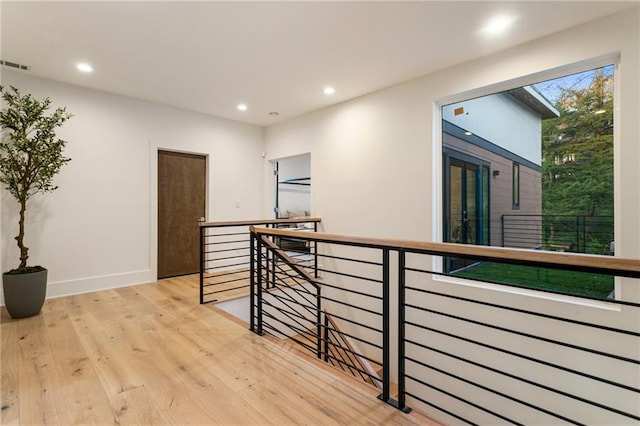 1045 Shepherds Ln NE, Atlanta, GA 30324 - hallway featuring visible vents, baseboards, light wood finished floors, recessed lighting, and an upstairs landing