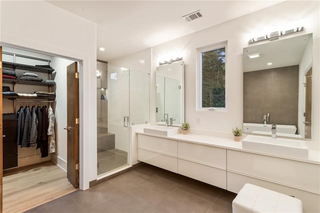 1045 Shepherds Ln NE, Atlanta, GA 30324 - full bath featuring a spacious closet, visible vents, a shower stall, tile patterned floors, and vanity