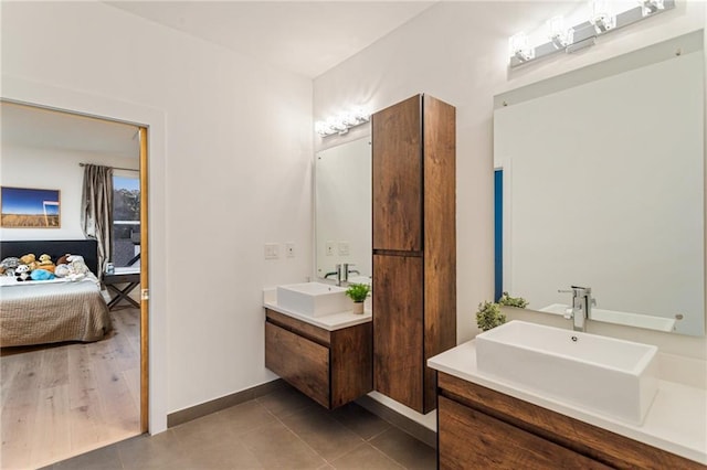 1045 Shepherds Ln NE, Atlanta, GA 30324 - ensuite bathroom featuring two vanities, baseboards, ensuite bathroom, and a sink