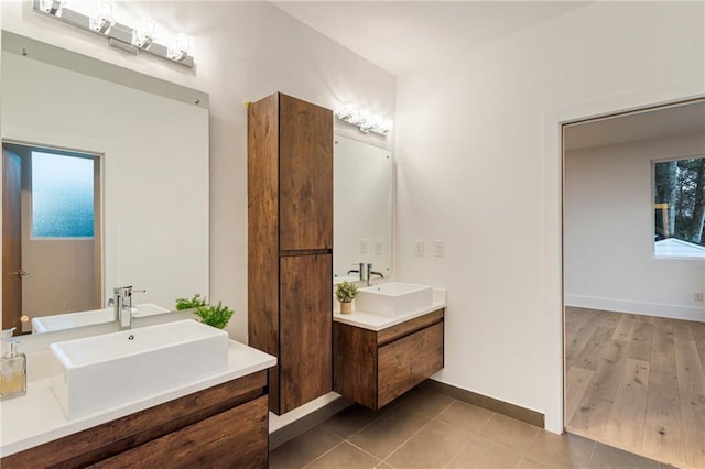 1045 Shepherds Ln NE, Atlanta, GA 30324 - bathroom featuring tile patterned flooring, two vanities, baseboards, and a sink