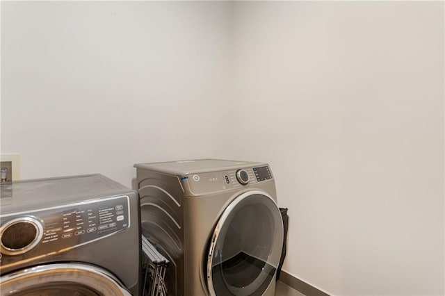 1045 Shepherds Ln NE, Atlanta, GA 30324 - clothes washing area with laundry area, baseboards, and separate washer and dryer