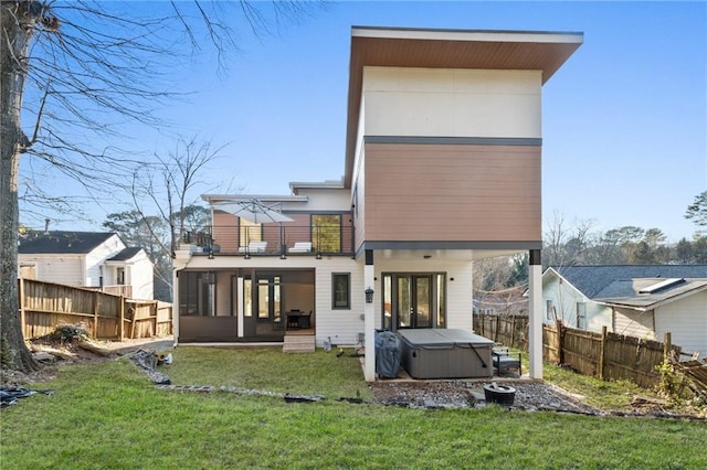1045 Shepherds Ln NE, Atlanta, GA 30324 - rear view of property with fence, a lawn, a sunroom, and a hot tub