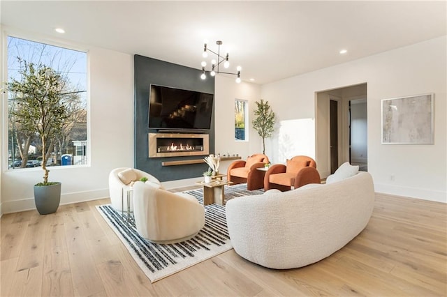 1045 Shepherds Ln NE, Atlanta, GA 30324 - living room featuring an inviting chandelier, recessed lighting, wood finished floors, and baseboards
