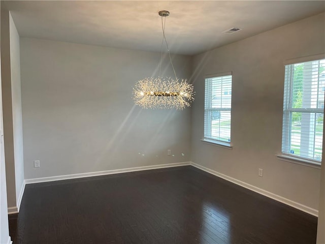 3172 Lowell Rd, Bethlehem, GA 30620 - spare room featuring a chandelier, dark wood-type flooring, and healthy amount of natural light