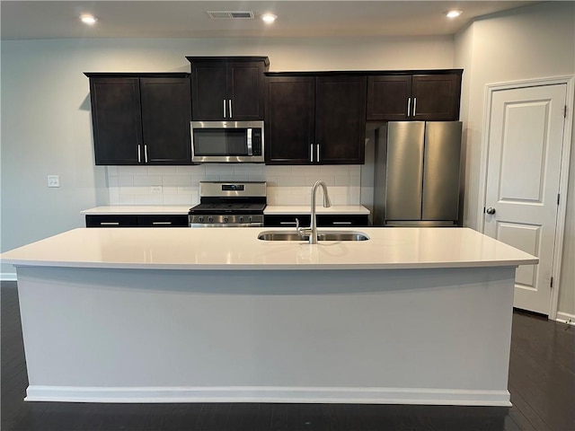 3172 Lowell Rd, Bethlehem, GA 30620 - kitchen featuring appliances with stainless steel finishes, an island with sink, backsplash, light countertops, and recessed lighting