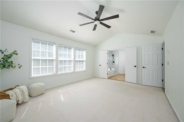 unfurnished bedroom featuring a ceiling fan, visible vents, vaulted ceiling, and carpet flooring