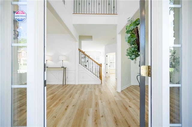 foyer with wood finished floors and stairs