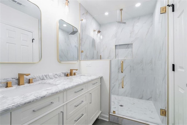 bathroom featuring vanity and an enclosed shower