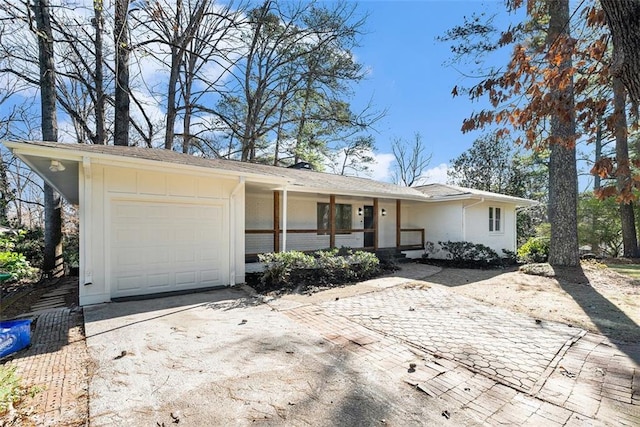 single story home with covered porch and a garage