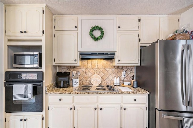 kitchen featuring under cabinet range hood, backsplash, a textured ceiling, and stainless steel appliances